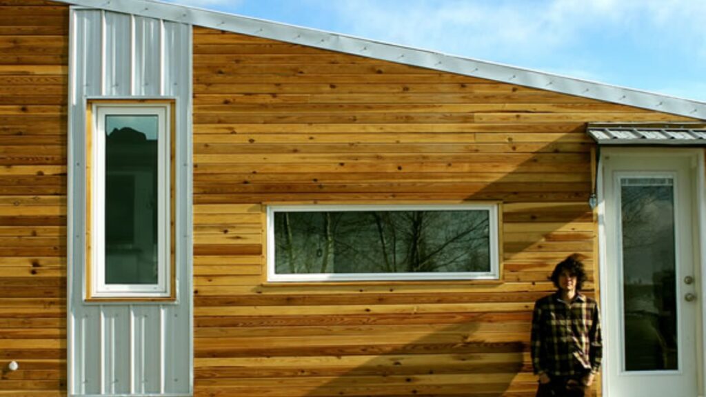 Leaf House – Mobile Home for Adventure Seeking Nomads A boy outside the tiny house