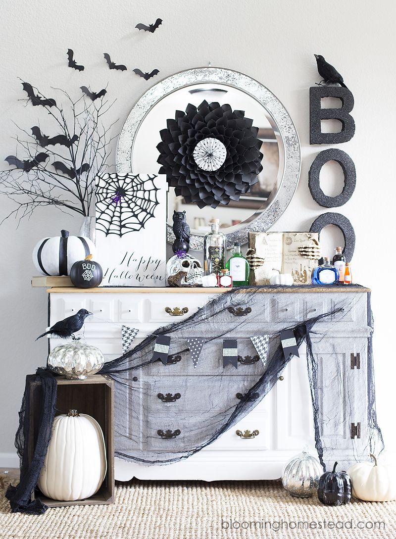 Add a pumpkin patch in front of a cabinet decked with halloween decorations  