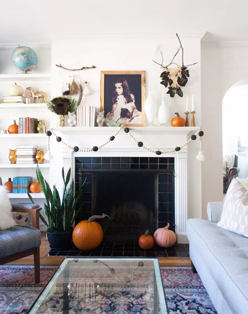 decorate fireplace mantel with garland and pumpkins  