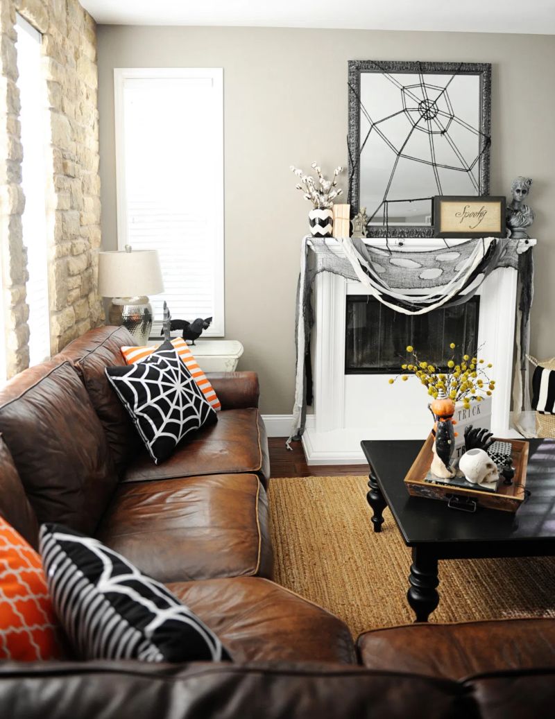 fireplace mantel decor with black and cheesecloth and spiderweb over mirror  