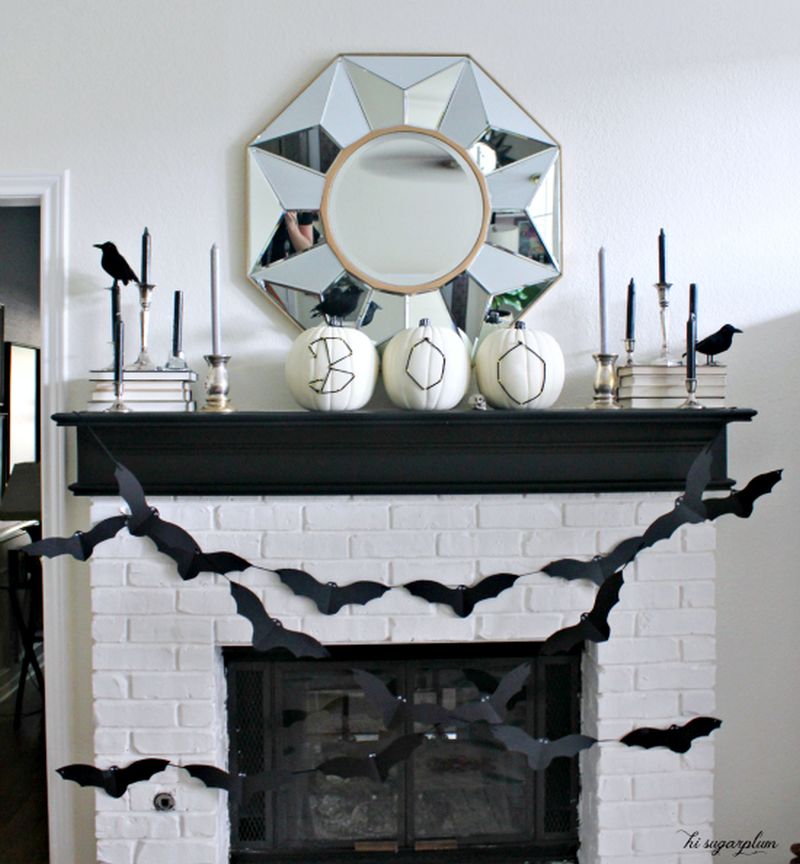 boo pumpkins to decorate fireplace mantel and bat garland 