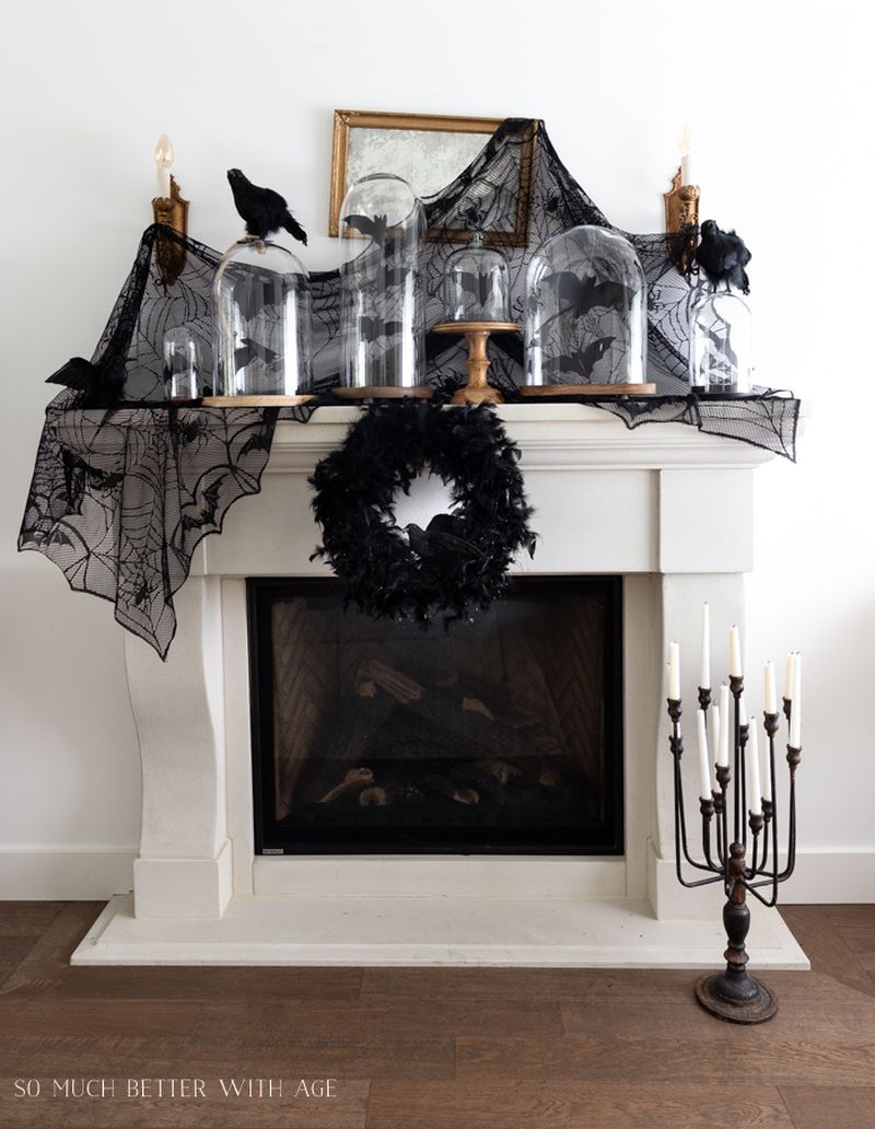 black wreath and bats to decorate fireplace mantel 