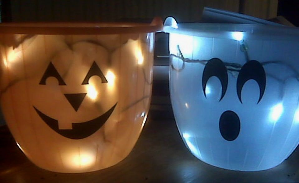 Scary ghost with halloween candy bucket and glowing Jack o lantern