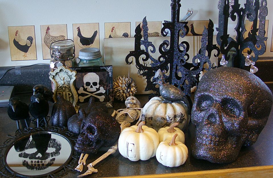 black glittery skulls, white pumpkins for halloween decor   