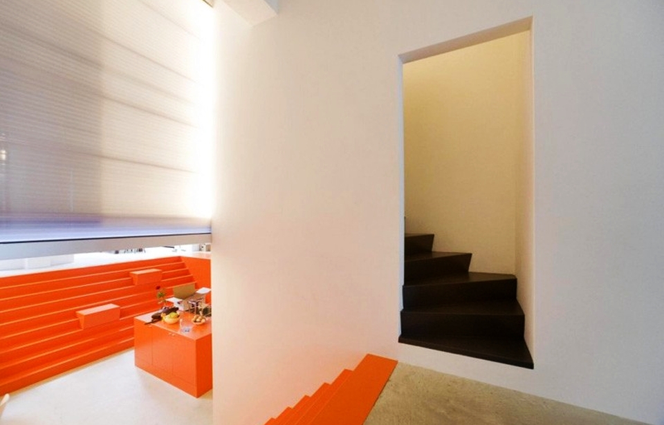 Ambulance garage turned into modern home with orange interior