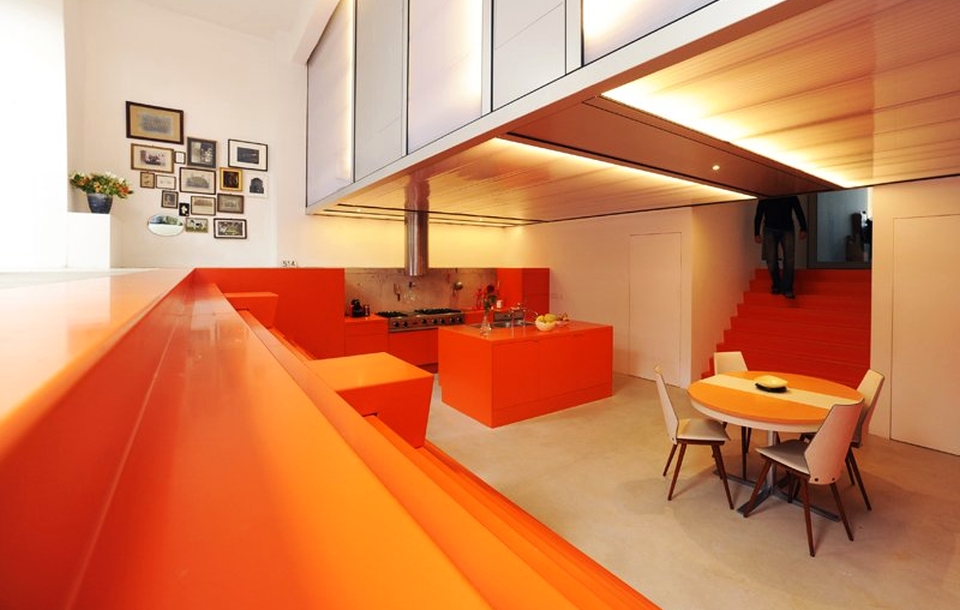 Ambulance garage turned into modern home with orange interior