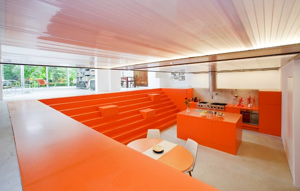 Ambulance garage turned into modern home with orange interior