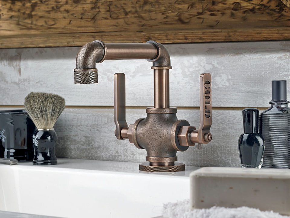 The faucets are finished with intricate knurled metal 