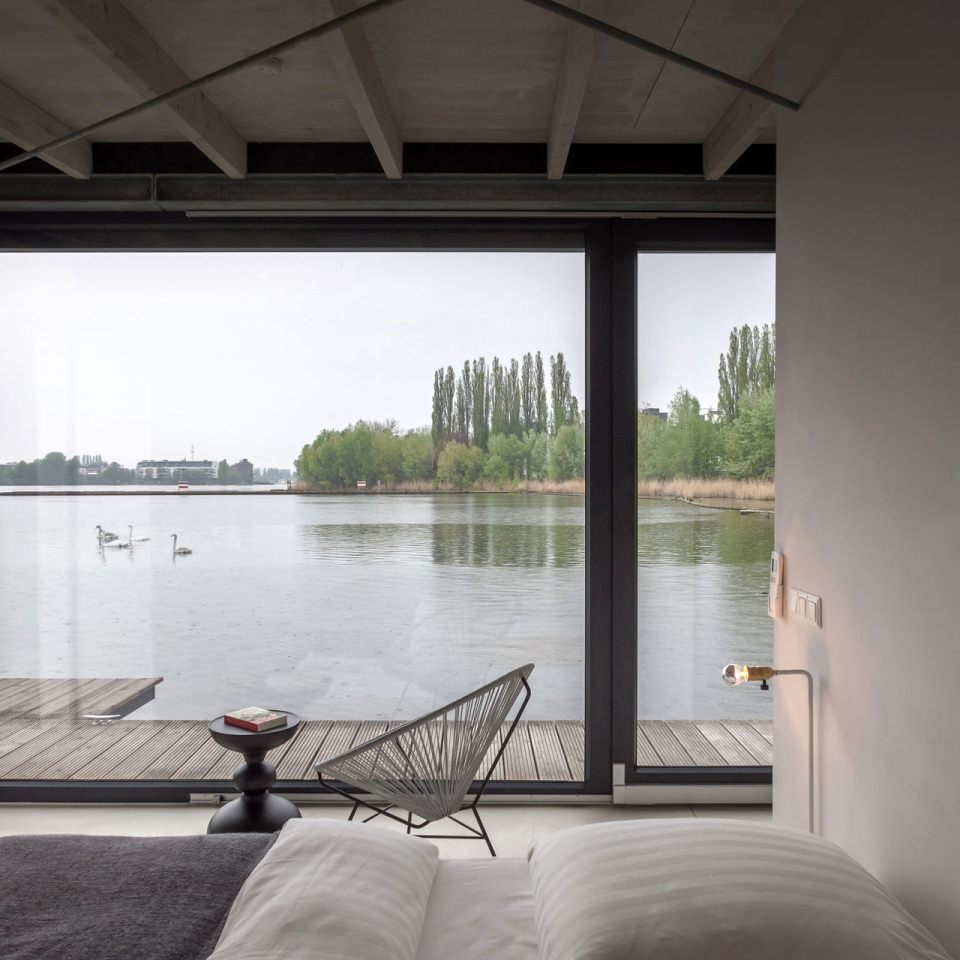 The main bedroom with beds overlooking the water