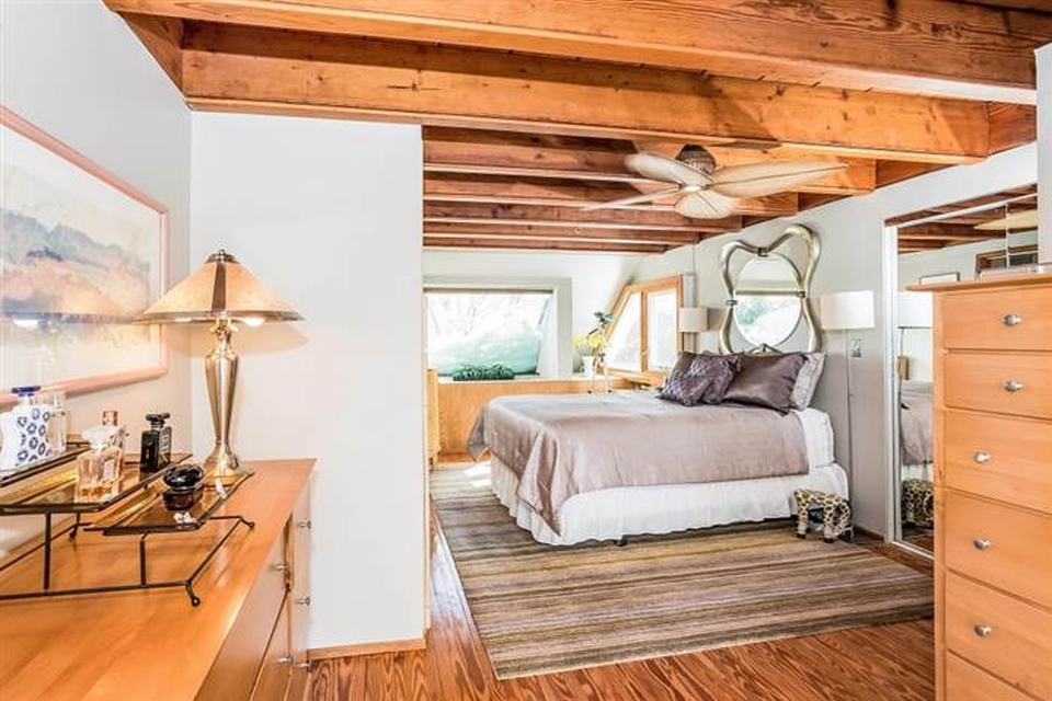 Spacious bedroom with full windows to allow natural light to come in