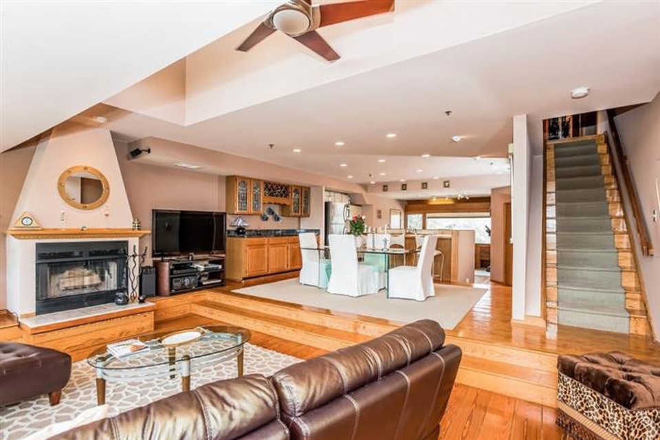 The living area with hardwood flooring and ample windows for proper ventilation and view of the Guildford wetlands