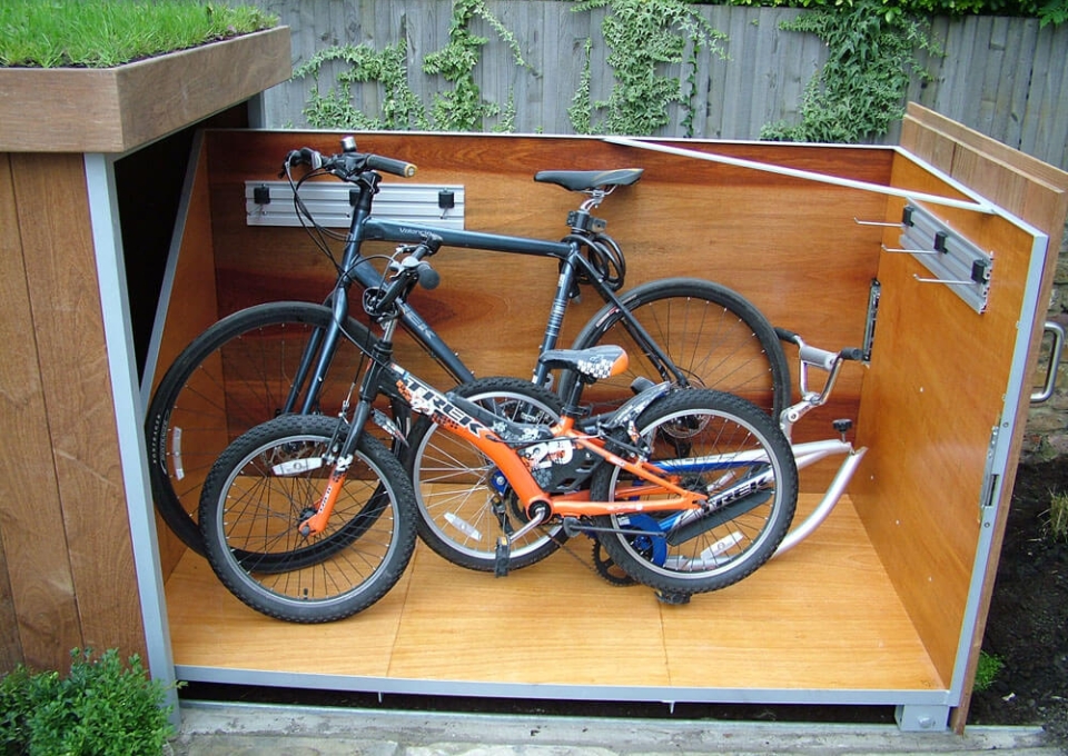 Contemporary outdoor bike locker doubles as clever green planter