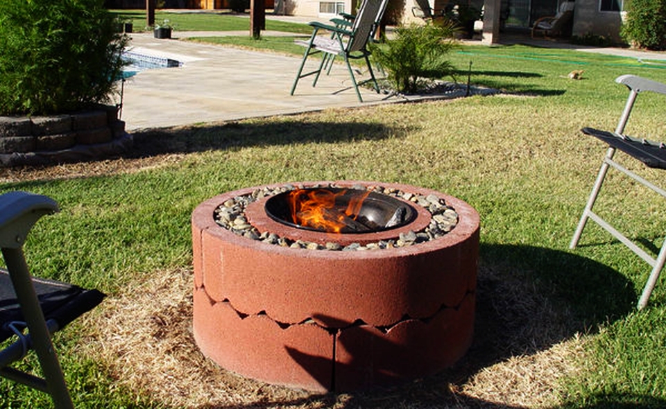 fire pit from stones, clay and a metal bowl 