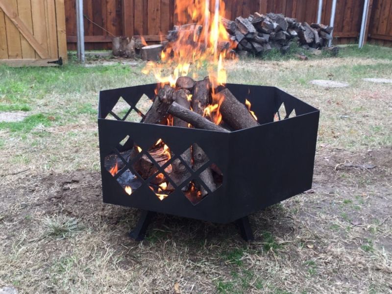 DIY steel fire pit with an intricate patter cut on the outside by April Wilkerson 