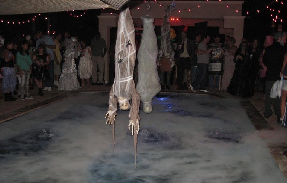 Hanging Zombies and Mummies for Halloween pool party decor 