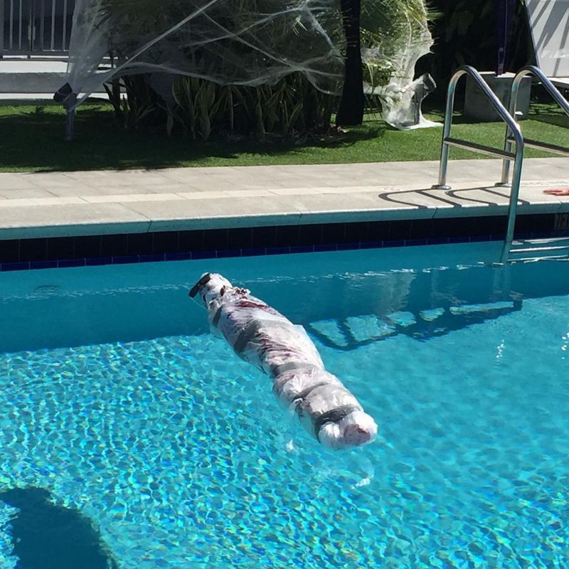 Dead Body wrapped in plastic in the Pool for halloween decor 