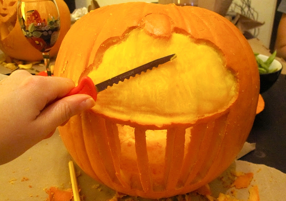 add finishing touches to carved pumpkin 