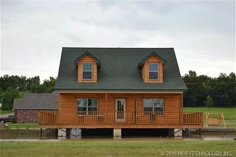 You can Buy this House with Fishing Hole in Living Room for $229K