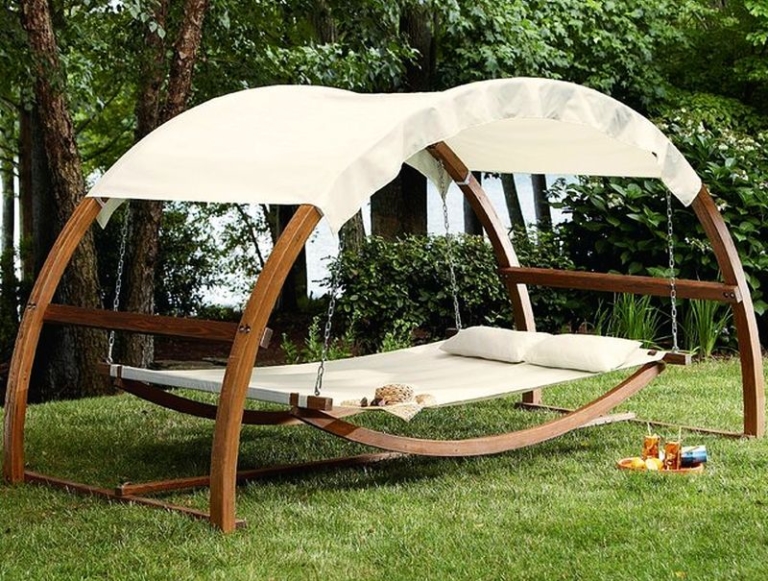 Swing bed with canopy turns ordinary garden into sumptuous refuge