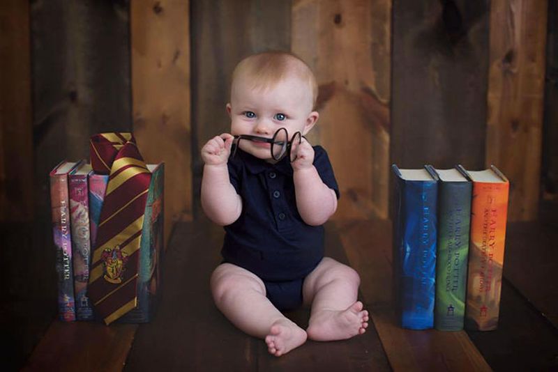 Kid with all seven books of the Harry Potter series