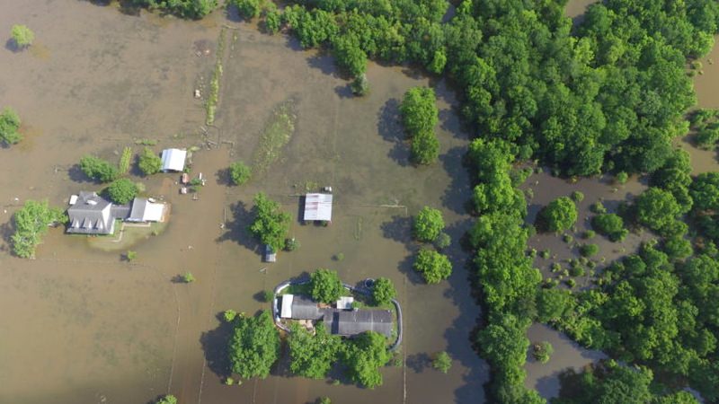 While other houses bear the wrath of flood, Randy's home sits dry and safe