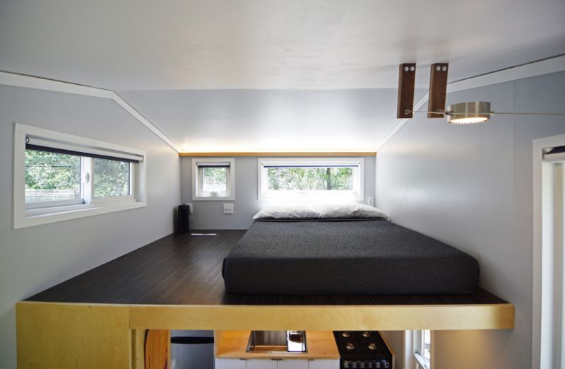 A loft bedroom with elongated windows 