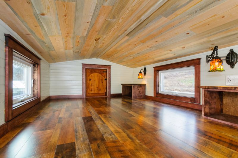 Wooden work all around the bedroom with white detailing 