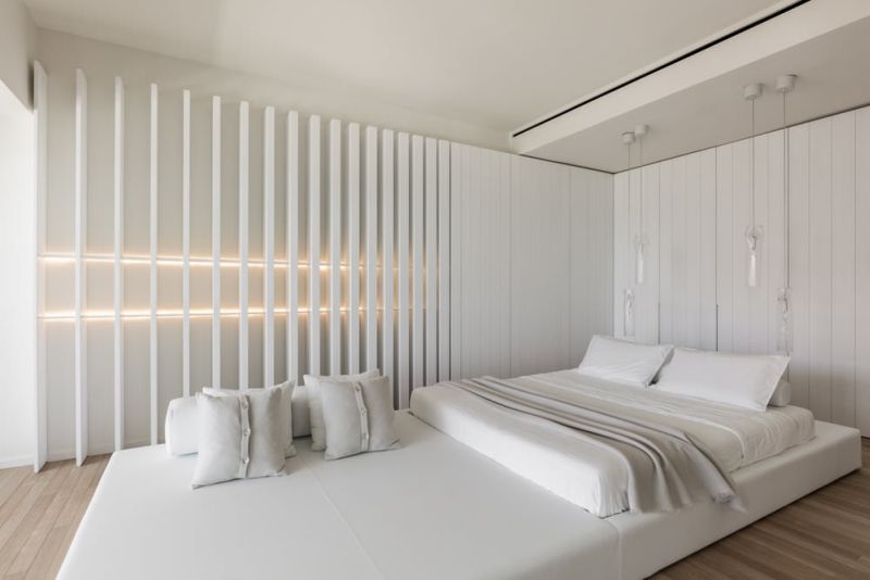 A 4-meter long white leather platform functions as a comfortable bed and a lounge area 