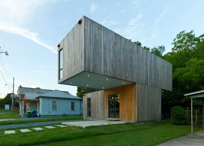 South-facing side is designed with vertical wooden plank siding 