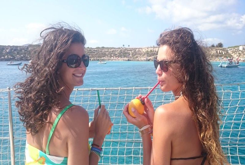 Enjoy fresh orange juice while sun bathing on a beach 