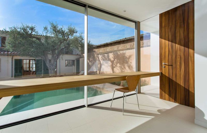 This home office in Spain overlooks a swimming pool