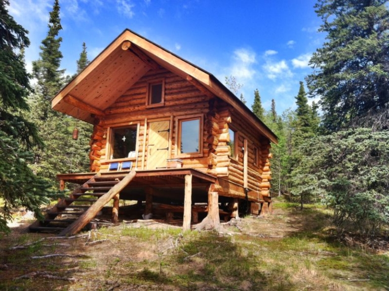 This log cabin in Alaska boasts wooden architecture & spacious kitchen