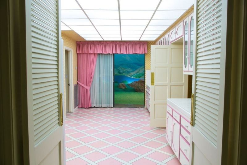 Kitchen with pink floor and white cabinets 