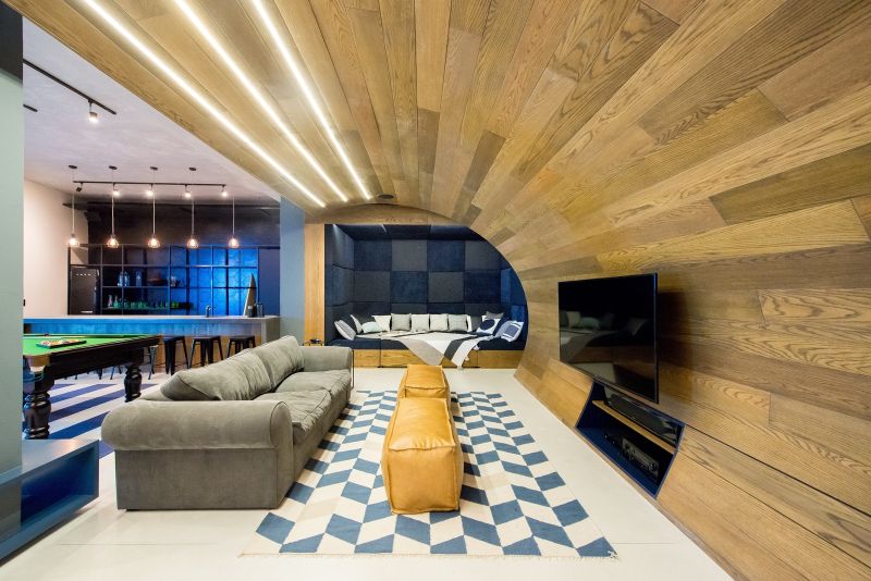 A floor-to-ceiling wooden arch over the lounge-cum-theater-area