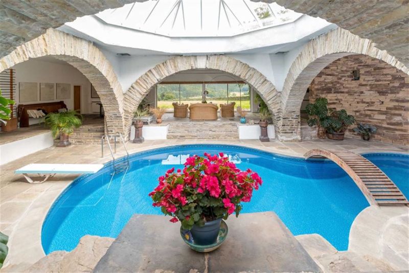 Stone arched walls and floor-to-ceiling doors serves as recreational area 