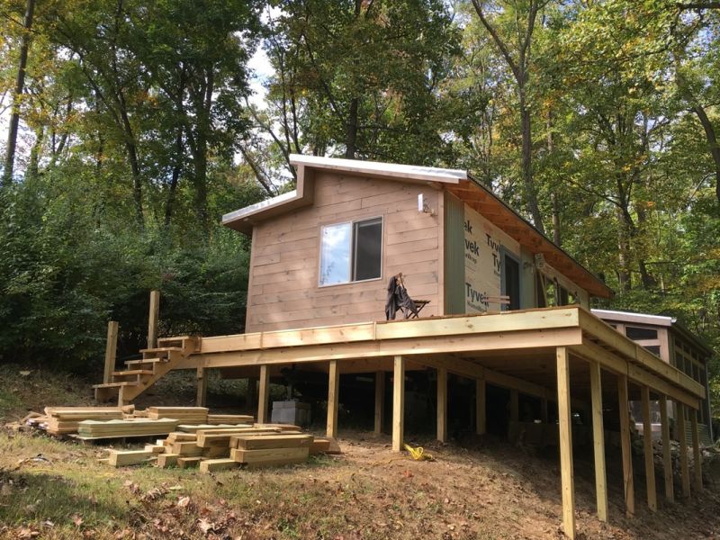 Tiny house structure raised on wooden beams 