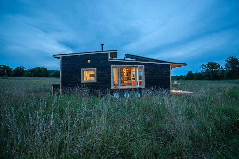 Features dual-pitched black metal roof 