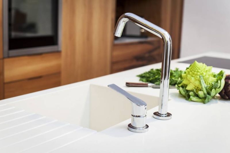 Kitchen island houses a sink and an induction top 