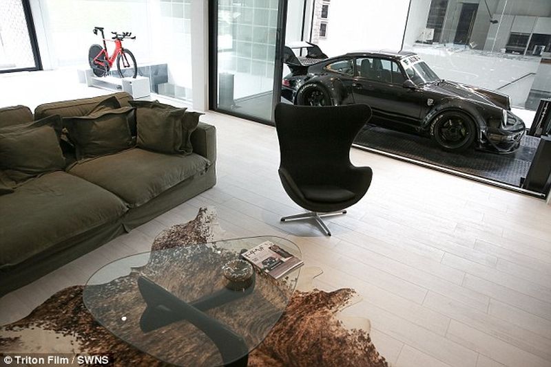 Thai man builds glass elevator in lounge to display his Porsche cars