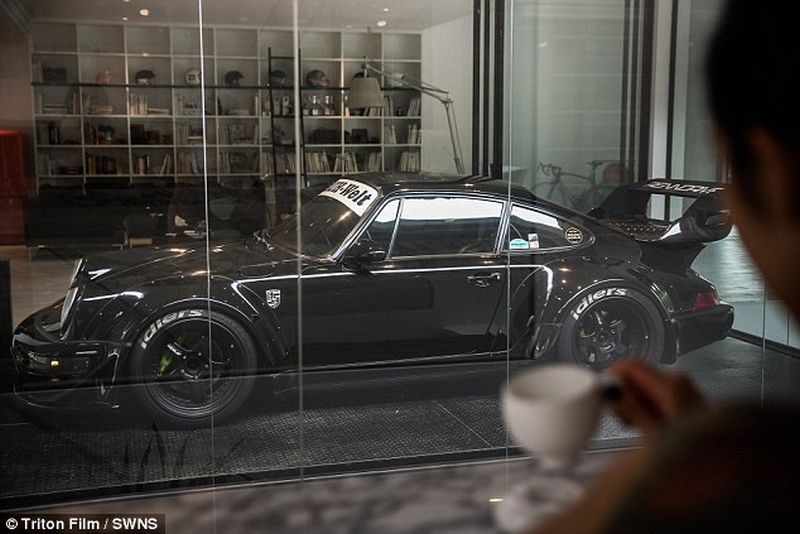 Thai man builds glass elevator in lounge to display his Porsche cars