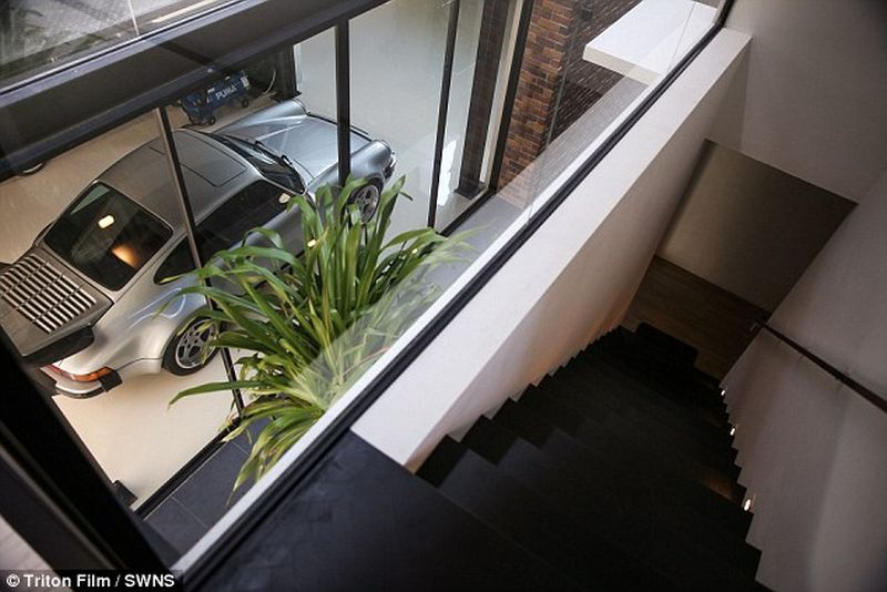 Thai man builds glass elevator in lounge to display his Porsche cars