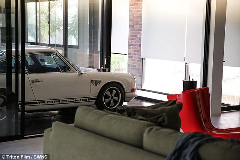 Thai man builds glass elevator in lounge to display his Porsche cars