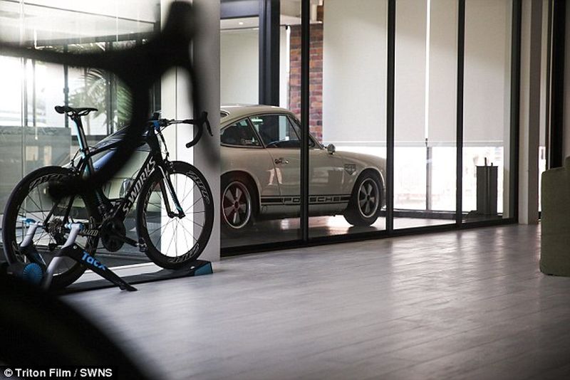 Thai man builds glass elevator in lounge to display his Porsche cars