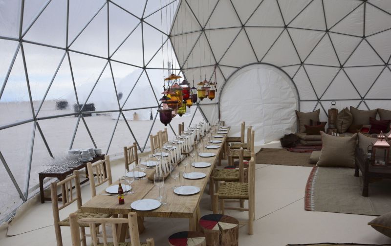 Dinner table for a group at a pop-up hotel in Bolivia's salt flats