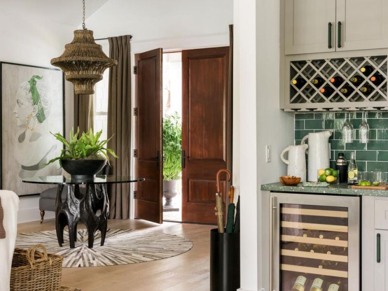 Wood beaded mini chandelier illuminates the foyer 