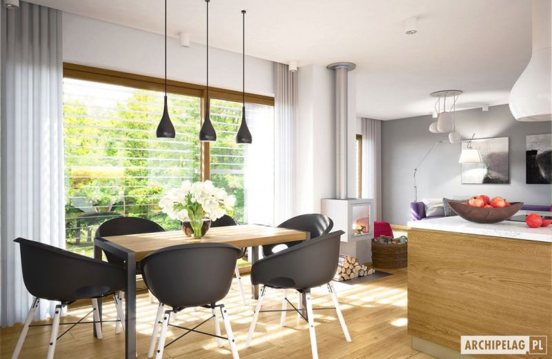 Dining space is furnished with a wooden table and charcoal black chairs