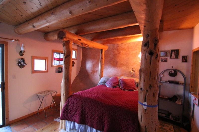 Master bedroom with exposed stone wall 