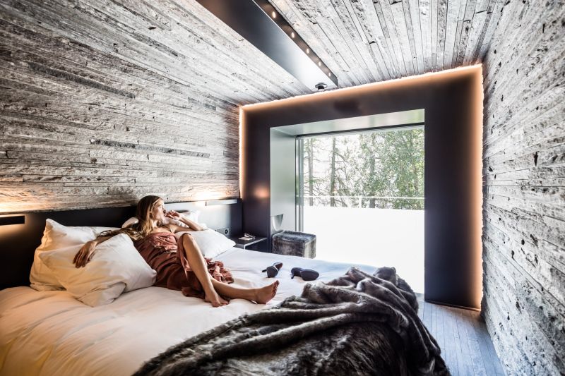 Hotel 7132’s wood and stone guest suites feature tinted glass shower