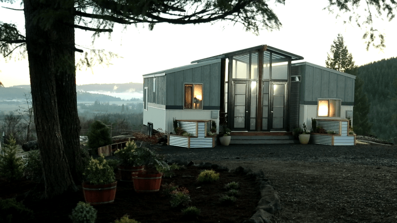 Ohana tiny house features a patio between two trailers