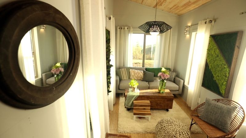 Ohana tiny house features a patio between two trailers